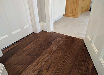 This walnut floor is fitted without a border, so the flooring runs straight up to the tiles