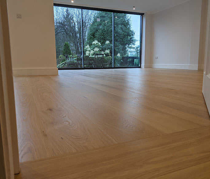 Oak floor directional change at a doorway towards natural light #CraftedForLife