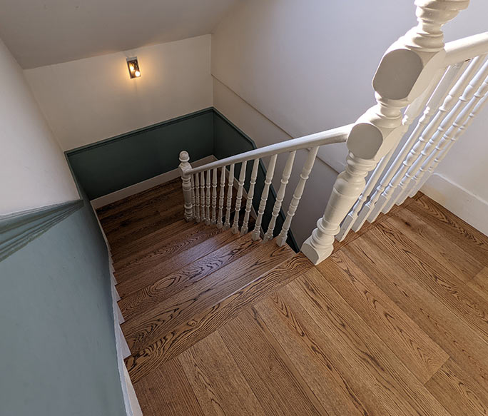 Oak stair cladding matching landing floor grain and finish #CraftedForLife