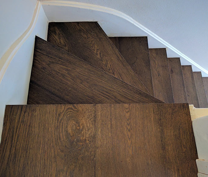 Profile-free dark oak stair landing transition with cladded steps #CraftedForLife