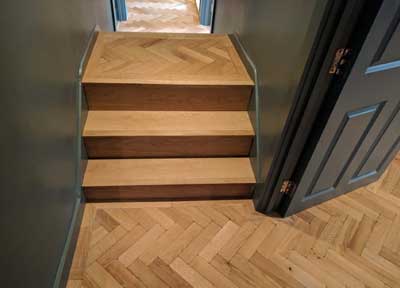 We made a feature out of these quirky steps by cladding them in engineered oak and then fitting the aged parquet on top