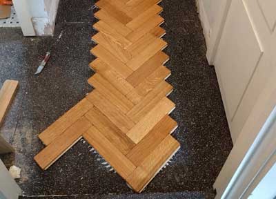 We usually start in the middle of a room and work our way outwards when fitting parquet.